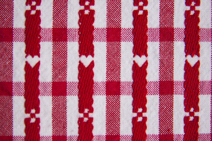 A close up of red and white stitched fabric