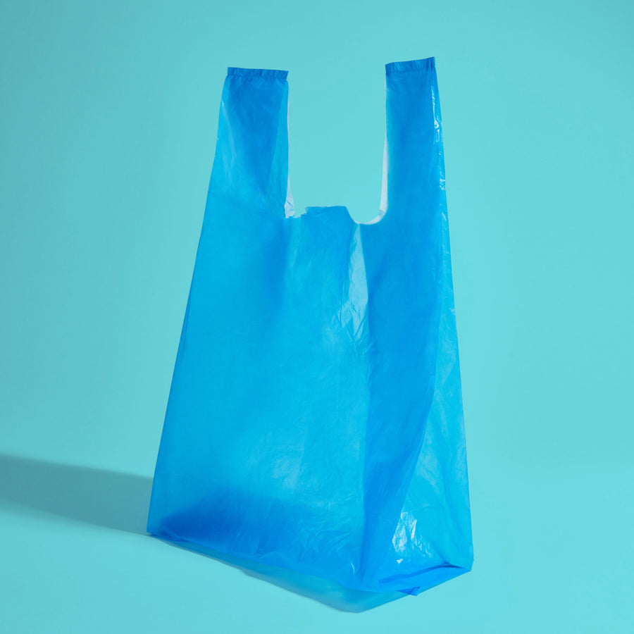 A blue plastic opaque bag with tie handles