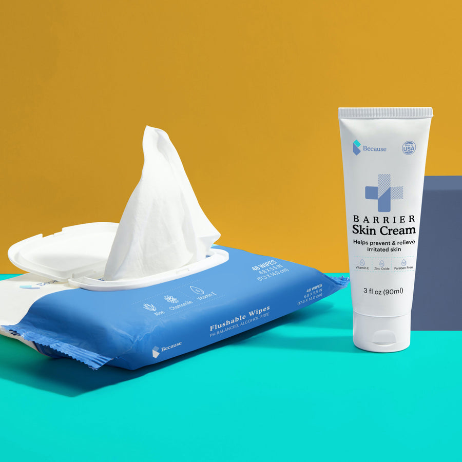 Flushable wipes sitting next to a tube of barrier skin cream