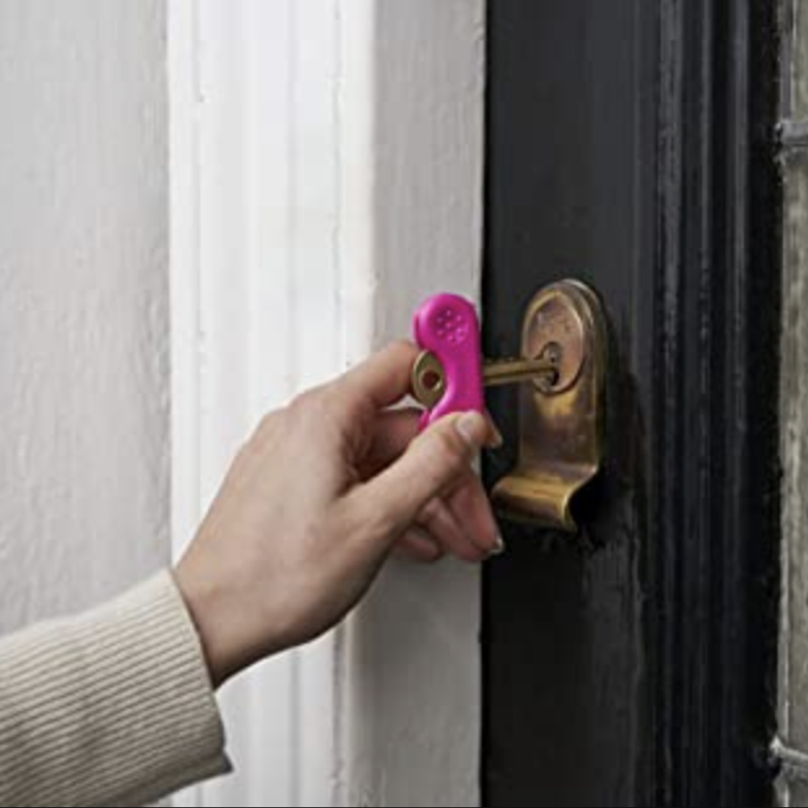 Hand using keywing grabber to turn the key inside the doorlock