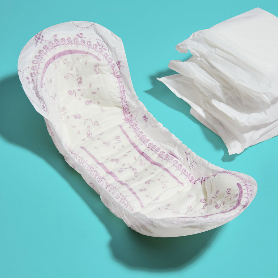Maximum absorbency pad contoured to fit a womans body