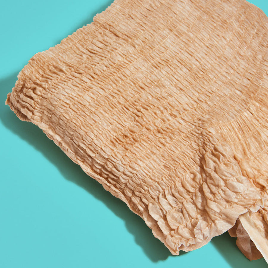 A close up of the beige underwear fabric looking soft, stretchy, and comfortable