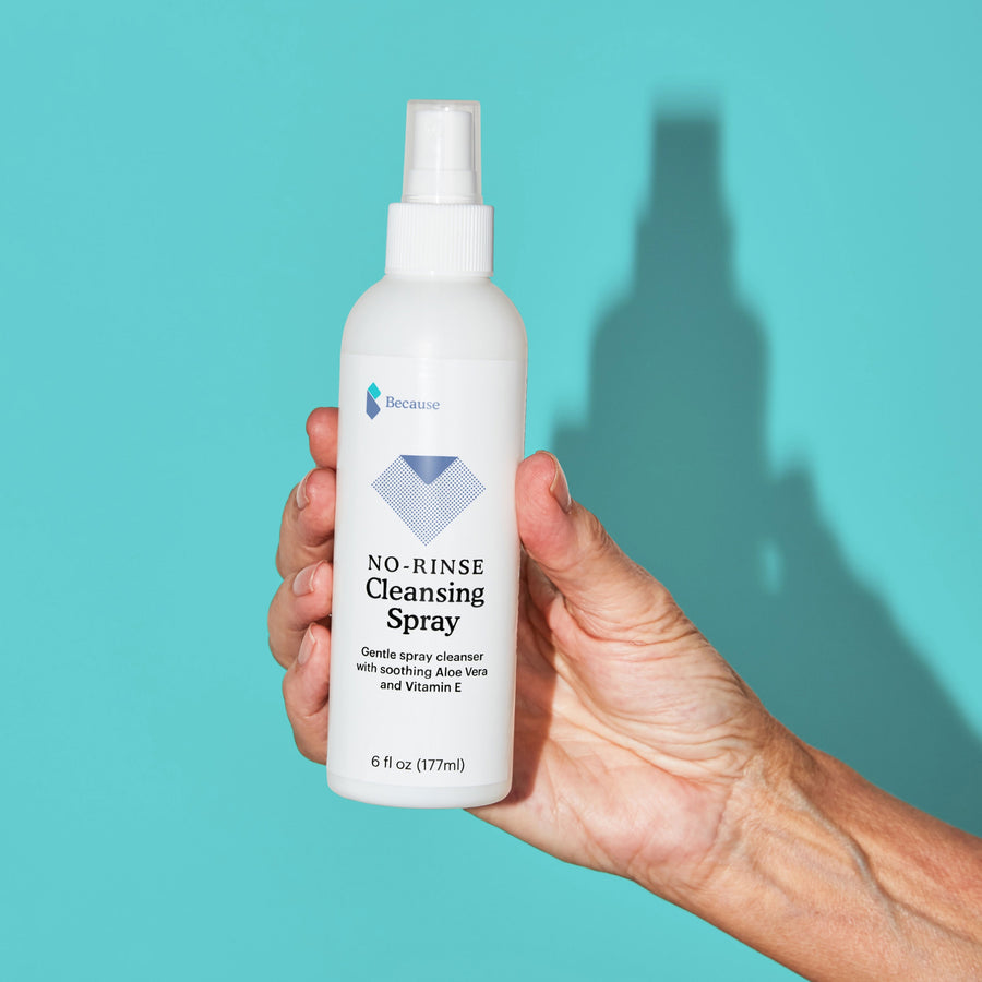 A woman holding no rinse cleansing spray in her hand